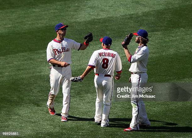 Raul Ibanez, Shane Victorino, and Jayson Werth of the Philadelphia Phillies celebrate after defeating the St. Louis Cardinals at Citizens Bank Park...