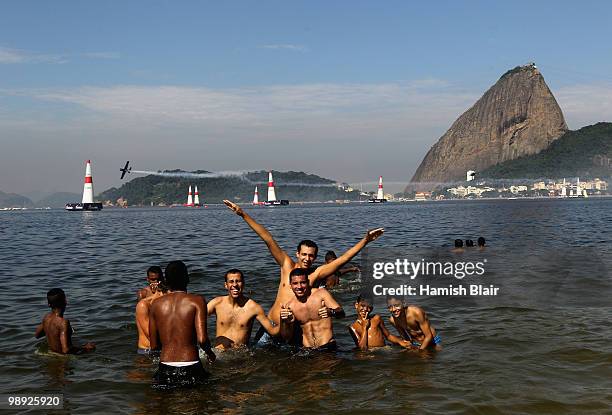 Fans on the beach watch Sergey Rakhmanin of Russia in action during the Red Bull Air Qualifying Day on May 8, 2010 in Rio de Janeiro, Brazil.