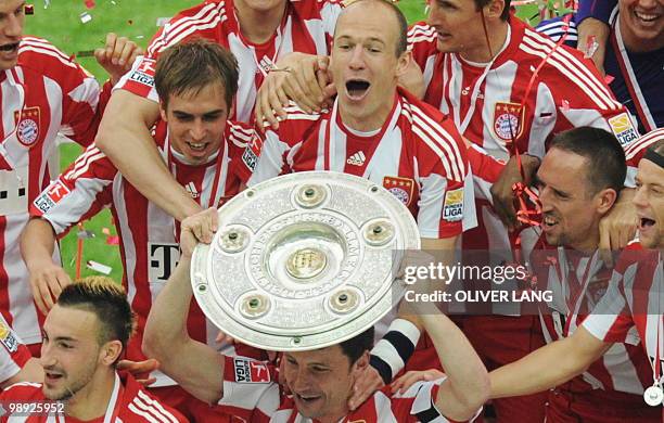 Bayern Munich celebrate with the Bundesliga trophy after the German first division Bundesliga football match Hertha BSC vs FC Bayern Munich in Berlin...