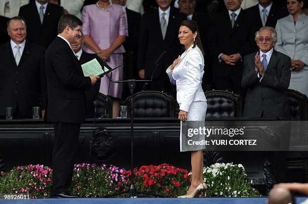 The head of the Legislative Assembly Gerardo Villanueva , takes oath to Costa Rican new President Laura Chinchilla, as her husband Jose Maria Rico...