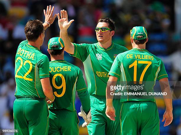 South African captain Graeme Smith and bowler Johan Botha celebrate after taking the wicket of English batsman Kevin Pietersen during the ICC World...