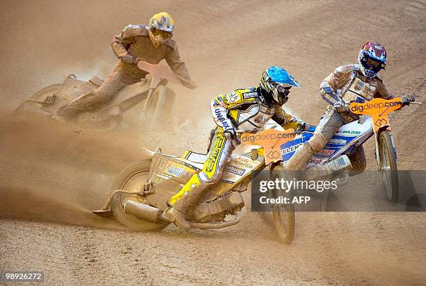 Denmark's Hans Andersen drives in front of Denmark's Nicki Pedersen and Australia's Jason Crump during the fifth heat of the Swedish Speedway Grand...