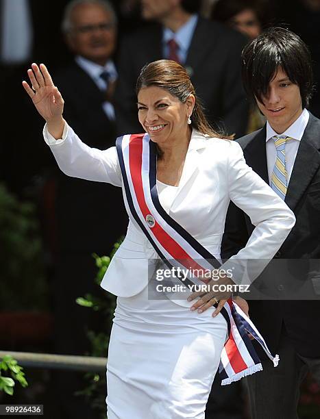 Followed by her son Jose Maria, Costa Rican new President Laura Chinchilla waves to the crowd after being sworn in at La Sabana Metropolitan Park in...