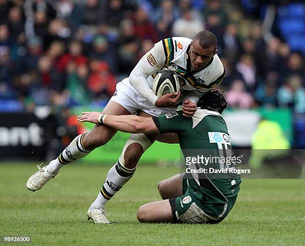 Courtney Lawes of Northampton is tackled by Dan Murphy during the Guinness Premiership match between London Irish and Northampton Saints at the...