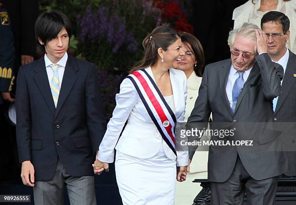 Costa Rican new President Laura Chinchilla prepares to leave with her husband Jose Maria Rico and son Jose Maria Rico, after her inauguration at La...