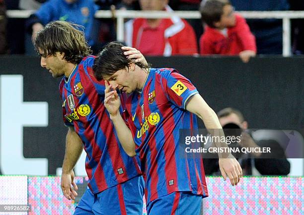Barcelona's Argentinian forward Lionel Messi celebrates with teammate Barcelona's Brazilian defender Maxwell after scoring against Sevilla during a...