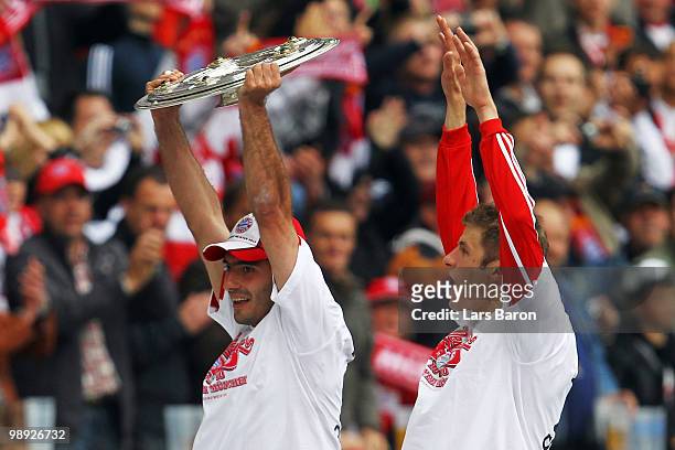 Hamit Altintop of Muenchen lifts the trophy with team mate Thomas Mueller after the Bundesliga match between Hertha BSC Berlin and FC Bayern Muenchen...
