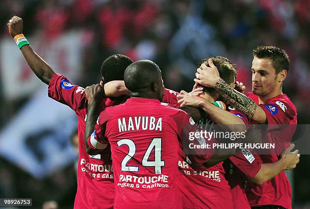 Lille's midfielder Yohan Cabaye is congratuled by teammates after scoring a goal during the French L1 football match Lille vs Marseille on May 8,...