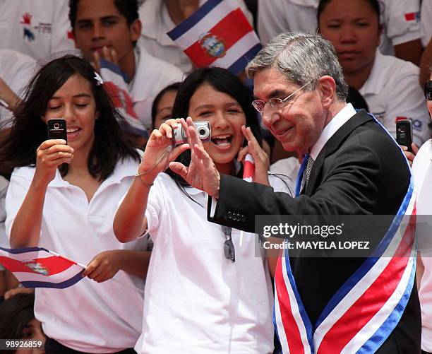 Costa Rican outgoing president Oscar Arias waves at the crowd during the inauguration ceremony at La Sabana Metropolitan Park in San Jose on May 8,...