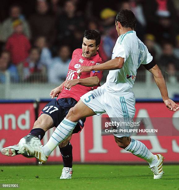Marseille's defender Hilton Vitorino vies with Lille's forward Pierre Alain Frau during their French L1 football match Lille vs Marseille on May 8,...