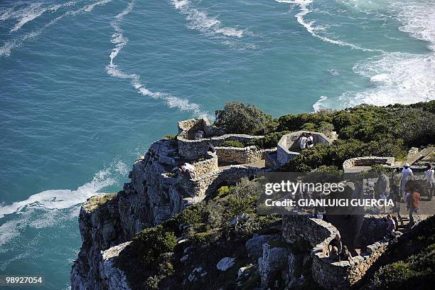 Tourists enjoy the view from Cape Point on May 8, 2010 on the southern tip of the Cape Peninsula, some 50 kms south of Cape Town, South Africa. When...