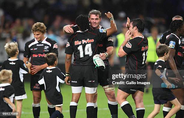 Steven Sykes and Odwa Ndunganeu of Sharks celebrate with teammates during the Super 14 match between Sharks and Vodacom Stormers at Absa Stadium on...