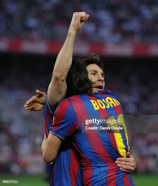 Lionel Messi of Barcelona celebrates with Bojan Krkic after scoring his team's first goal during the La Liga match between Sevilla and Barcelona at...