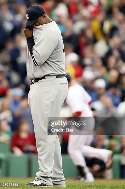 Sabathia of the New York Yankees reacts as Victor Martinez of the Boston Red Sox rounds third base after he hit a two run homer in the third inning...