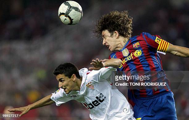 Sevilla's midfielder Jesus Navas vies for the ball with Barcelona's captain Carles Puyol during their Spanish league football match at Ramon Sanchez...