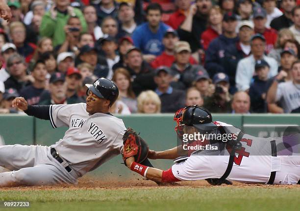 Victor Martinez of the Boston Red Sox tags out Randy Winn of the New York Yankees on May 8, 2010 at Fenway Park in Boston, Massachusetts.