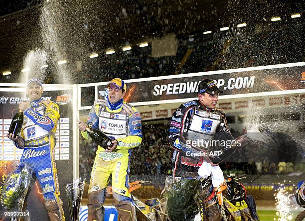 Denmark's Kenneth Bjerre sprays champagne after winning the Swedish Speedway Grand Prix with second placed Tomasz Gollob of Poland and third placed...