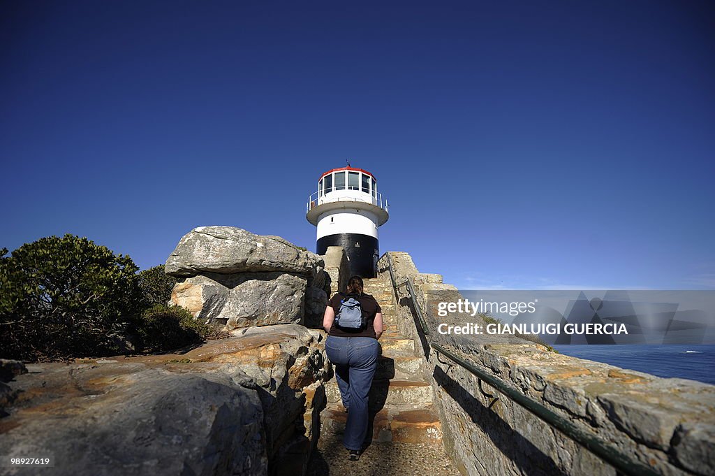 Tourists walk up to the Cape Point Light