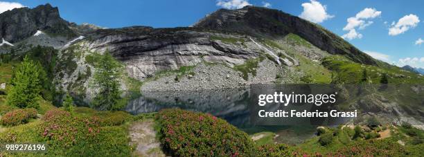 panoramic view of lago del paione inferiore in bognanco valley - heather brooke stock pictures, royalty-free photos & images