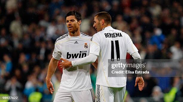 Karim Benzema of Real Madrid celebrates with Xabi Alonso after scoring during the La Liga match between Real Madrid and Athletic Club at Santiago...