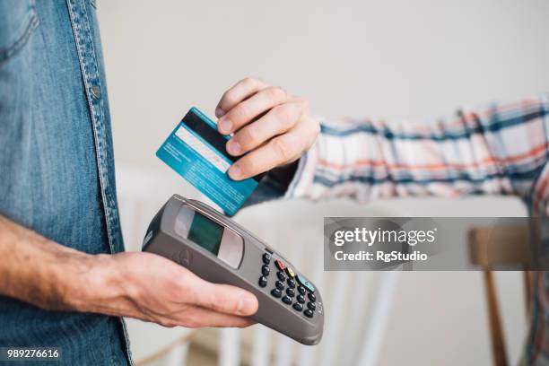 credit card in a credit card reader - smart card reader stock pictures, royalty-free photos & images