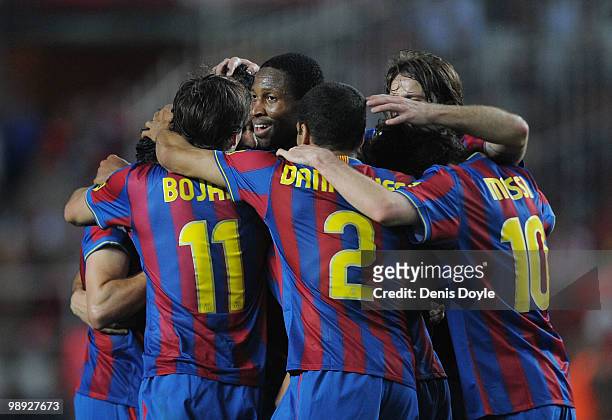 Seydou Keita of Barcelona players celebrates with teammates after Barcelona scored their 3rd goal during the La Liga match between Sevilla and...
