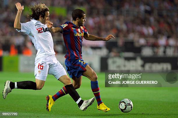 Barcelona's Brazilian defender Dani Alves vies for the ball with Sevilla's midfielder Diego Capel during a Spanish league football match at Ramon...