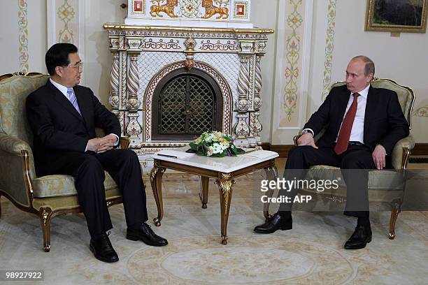 Russian Prime Minister Vladimir Putin and Chinese President Hu Jintao talk as they meet in Novo-Ogaryovo residence, outside of Moscow, on May 8,...