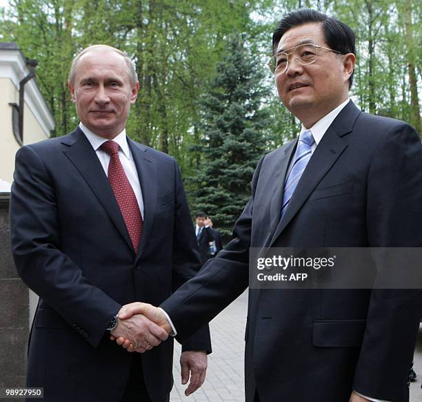 Russian Prime Minister Vladimir Putin and China's President Hu Jintao shake hands as they meet in Novo-Ogaryovo residence, outside of Moscow on May...