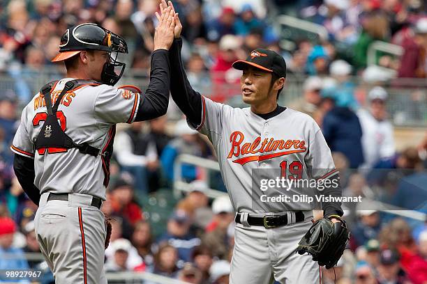 Relief pitcher Koji Uehara and Matt Wieters both of the Baltimore Orioles celebrate their victory against the Minnesota Twins at Target Field on May...