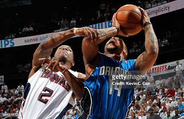 Jameer Nelson of the Orlando Magic is fouled by Joe Johnson of the Atlanta Hawks during Game Three of the Eastern Conference Semifinals during the...