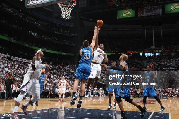 Joe Johnson of the Atlanta Hawks puts up a shot against Ryan Anderson of the Orlando Magic in Game Three of the Eastern Conference Semifinals during...