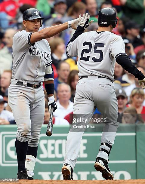 Mark Teixeira of the New York Yankees celebrates with teammate Alex Rodriguez after Teixeira hit a solo home run in the fifth inning against the...