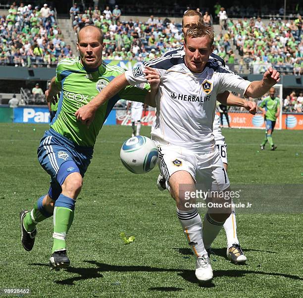Chris Birchall of the Los Angeles Galaxy battles Freddie Ljungberg of the Seattle Sounders FC on May 8, 2010 at Qwest Field in Seattle, Washington....