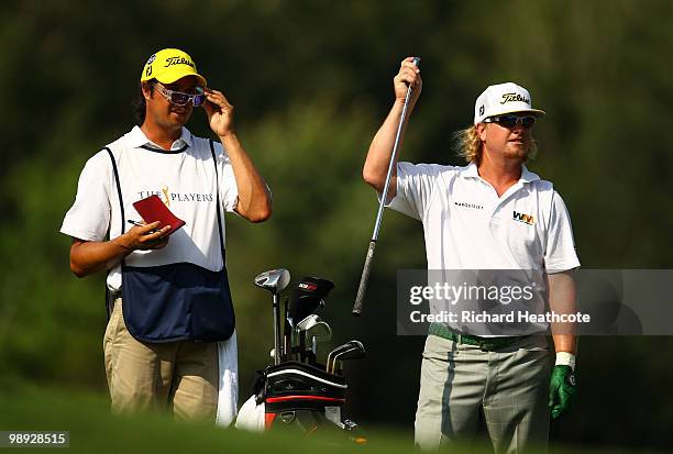 Charley Hoffman pulls a club from his bag alongside his caddie Miguel Rivera on the 14th hole during the third round of THE PLAYERS Championship held...