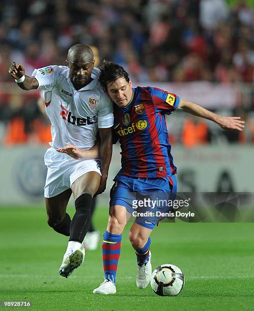Lionel Messi of Barcelona is tackled by Didier Zokora of Sevilla during the La Liga match between Sevilla and Barcelona at Estadio Ramon Sanchez...