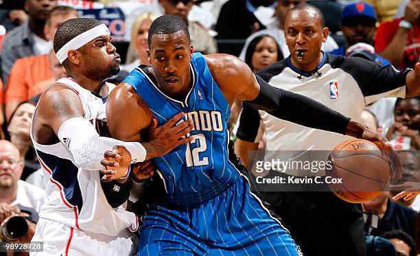 Dwight Howard of the Orlando Magic drives against Josh Smith of the Atlanta Hawks during Game Three of the Eastern Conference Semifinals during the...