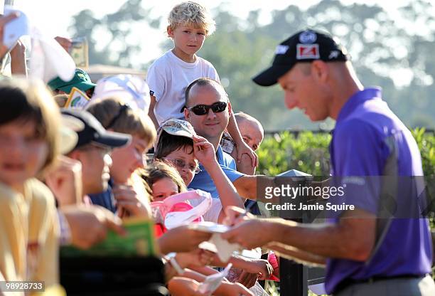 Young fan looks on as Jim Furyk signs autographs following the second round of THE PLAYERS Championship on THE PLAYERS Stadium Course at TPC Sawgrass...