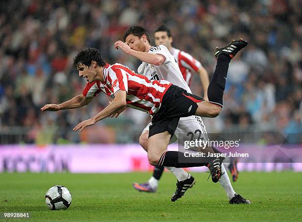Xabi Alonso of Real Madrid fights for the ball with Ion Velez of Athletic Bilbao during the La Liga match between Real Madrid and Athletic Bilbao at...