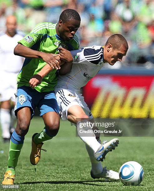 Steve Zakuani of the Seattle Sounders FC battles Bryan Jordan of the Los Angeles Galaxy on May 8, 2010 at Qwest Field in Seattle, Washington. The...