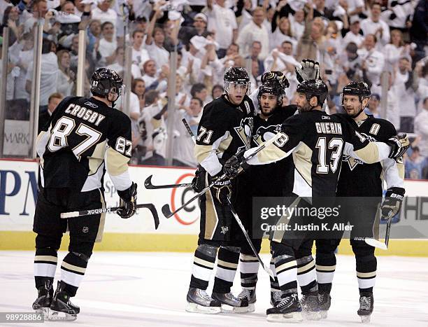 Kris Letang of the Pittsburgh Penguins celebrates his power play goal with teammates against the Montreal Canadiens in Game Five of the Eastern...