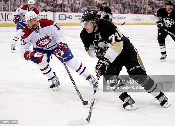 Evgeni Malkin of the Pittsburgh Penguins handles the puck against Glen Metropolit of the Montreal Canadiens in Game Five of the Eastern Conference...