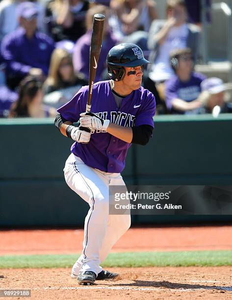 Center fielder Nick Martini of the Kansas State Wildcats drives a base hit to center field during a game against the Texas Longhorns at Tointon...