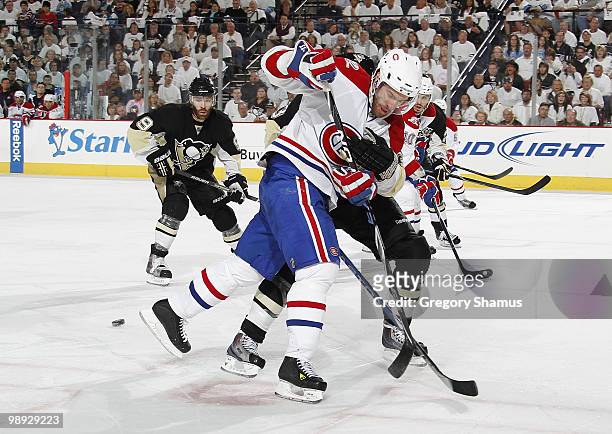 Dominic Moore of the Montreal Canadiens battles for the puck against a Pittsburgh Penguins defender in Game Five of the Eastern Conference Semifinals...