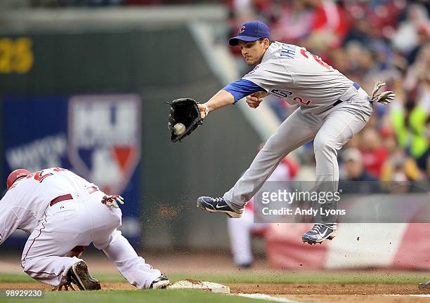 Ryan Theriot of the Chicago Cubs catches the ball as Ryan Hanigan slides safely into first base during the game against the Cincinnati Reds at Great...