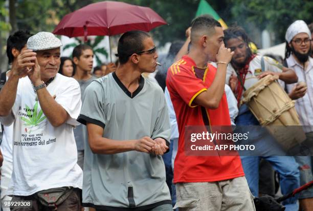 Men smoke marijuana while others play music and dance during the International Day for the Legalization of Marijuana in Medellin, Antioquia...