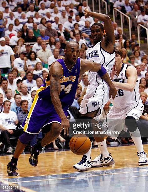 Kobe Bryant of the Los Angeles Lakers drives past C.J. Miles and Kyle Korver of the Utah Jazz during Game Three of the Western Conference Semifinals...