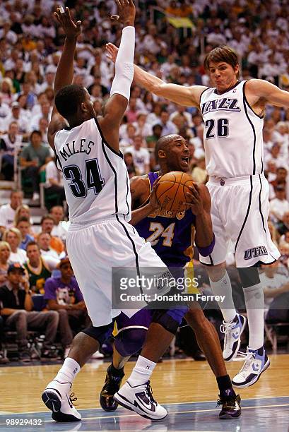 Kobe Bryant of the Los Angeles Lakers is defended by C.J. Miles and Kyle Korver of the Utah Jazz during Game Three of the Western Conference...