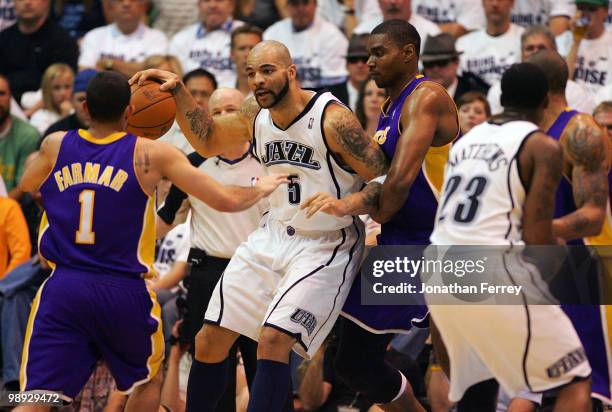 Carlos Boozer of the Utah Jazz is guarded by Andrew Bynum of the Los Angeles Lakers during Game Three of the Western Conference Semifinals of the...