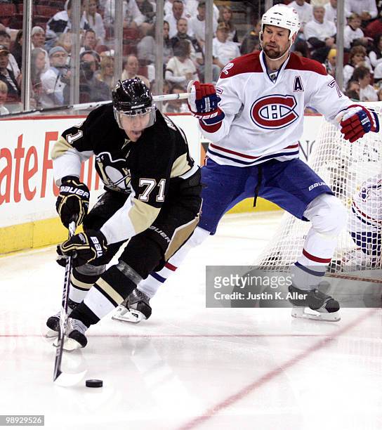 Evgeni Malkin of the Pittsburgh Penguins handles the puck in front of Hal Gill of the Montreal Canadiens in Game Five of the Eastern Conference...